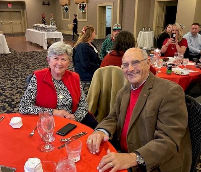 Tony and Phyllis sitting down at a table.