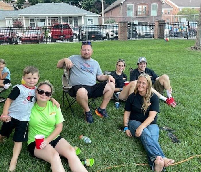 SERVPRO employees sitting in the lawn